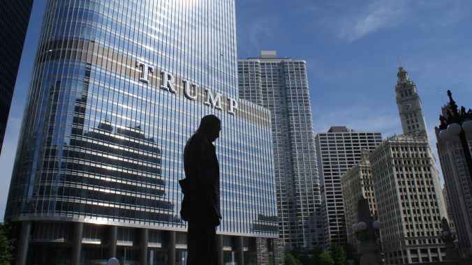 silhouette of statue near trump building at daytime